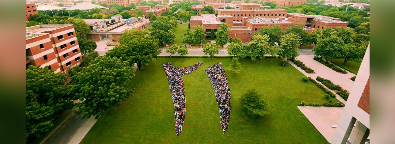 Aerial shot of students forming the digits of 21 in urdu 